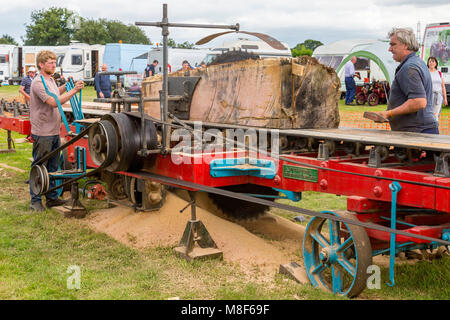 A demonstration of a saw bench driven by a traction engine at the 2017 Norton Fitzwarren Steam Rally, Somerset, England, UK Stock Photo