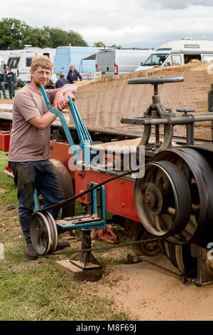 A demonstration of a saw bench driven by a traction engine at the 2017 Norton Fitzwarren Steam Rally, Somerset, England, UK Stock Photo