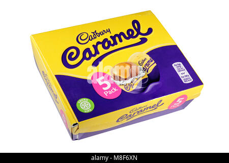 A box of 5 Cadburys Caramel Eggs with two loose isolated on a white background Stock Photo