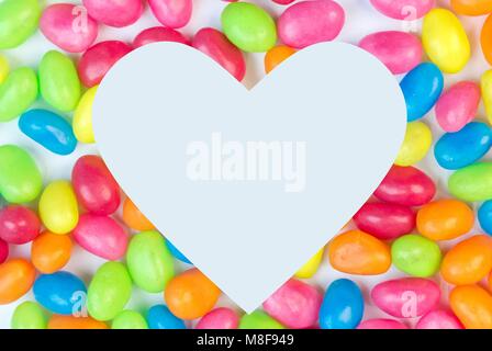Colorful jelly bean background with white heart shaped space for text copy space Stock Photo