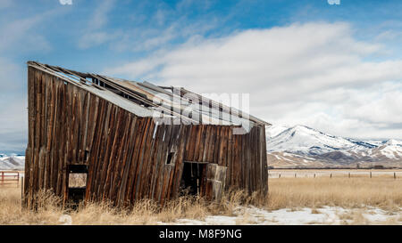 Wooden abandoned bullding on a farm in winter Stock Photo
