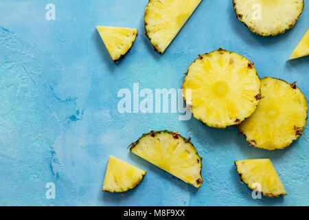 Fresh slice pineapple on stone background or slate with copy space. Food concept. Top view flat lay background. Stock Photo