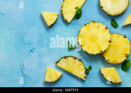 Fresh slice pineapple on stone background or slate with copy space. Food concept. Top view flat lay background. Stock Photo