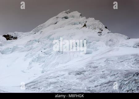 the summit of Nevado Yanapaccha peak in the Cordillera Blanca with the ascent route over the glacier in the foreground Stock Photo