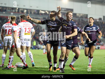 Leeds Rhinos Matt Parcell (centre) celebrates his try against St Helens, during the Betfred Super League match at The Totally Wicked Stadium, St Helens. Stock Photo