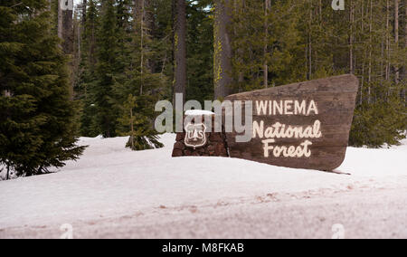 Fresh snow covering the bondary marker sign entering Winema National Forest Oregon Stock Photo