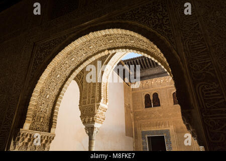 GRANADA, SPAIN - MAY 2017: Inside Alhambra Nasrid Palaces, plaster inscriptions on arches, view from inside Stock Photo