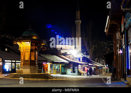 SARAJEVO, BOSNIA-ERZEGOVINA - FEBRUARY, 16: Night view of the Sebilj wooden fountain and Bascarsijska Dzamija minaret in Bascarsija square on February Stock Photo