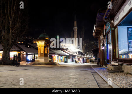 SARAJEVO, BOSNIA-ERZEGOVINA  - FEBRUARY, 16: Night view of the Sebilj wooden fountain and Bascarsijska Dzamija minaret in Bascarsija square on Februar Stock Photo