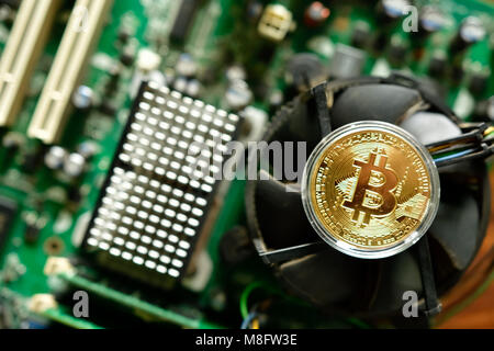 Close up of virtual currency bitcoin on computer motherboard Stock Photo