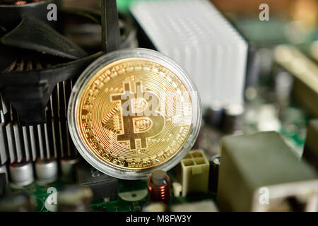 Close up of virtual currency bitcoin on computer motherboard Stock Photo
