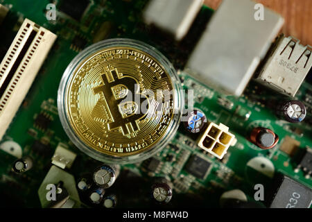 Close up of virtual currency bitcoin on computer motherboard Stock Photo