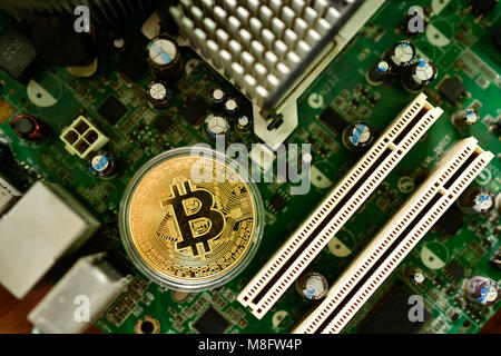 Close up of virtual currency bitcoin on computer motherboard Stock Photo