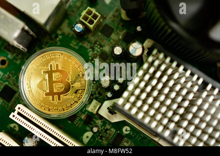Close up of virtual currency bitcoin on computer motherboard Stock Photo
