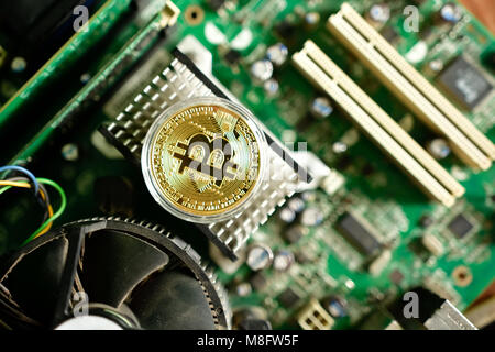 Close up of virtual currency bitcoin on computer motherboard Stock Photo