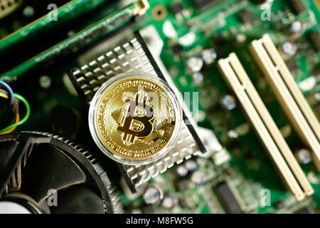 Close up of virtual currency bitcoin on computer motherboard Stock Photo