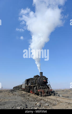 Locomotive of a spoil train at the tip in Fuxin. The coal mine system ...