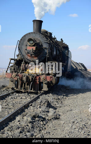Locomotive of a spoil train at the tip in Fuxin. The coal mine system ...