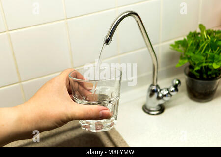 Clear transparent cold water flows from the tap Stock Photo