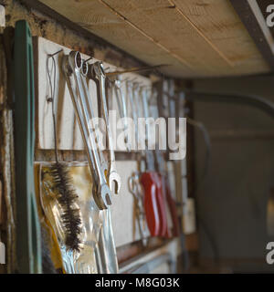 Various hand tools hanging on a rack, square shallow depth of field shot Stock Photo