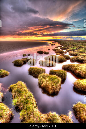 Solway Firth, Scotland. Picturesque view of sunset over the Solway Firth saltmarsh and beach, near the village of Powfoot. Stock Photo