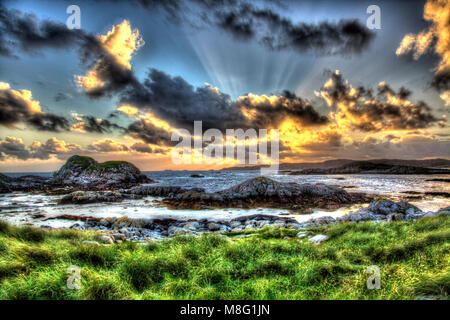 Isle of Mull, Scotland. Artistic sunset view from Fidden Beach on the west coast of Mull, with the Isle of Iona in the background. Stock Photo
