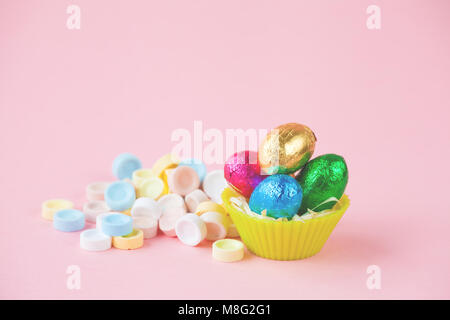 Easter Eggs Chocolates mini basket closeup with drops Stock Photo