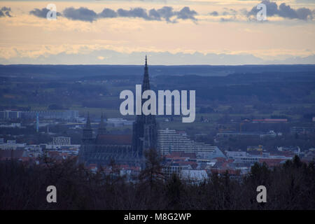 blue optic look of a distant view over the city of ulm include the minster of ulm and the alps in the background