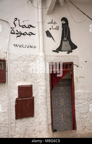 Morocco, Casablanca, Medina, sign showing Islamic woman wearing full veil above doorway Stock Photo