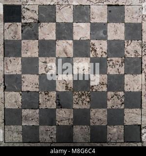 Background: weathered stone chessboard Stock Photo