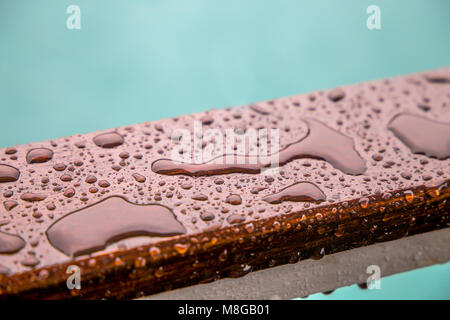 Raindrops on wooden railing/ drips / water/ rain Stock Photo