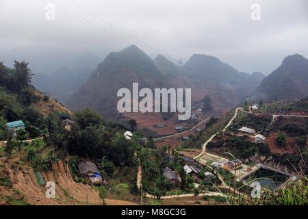 Ha Giang, Vietnam - March 18, 2018: Village surrounded by mountains and fog in the northernmost province of Vietnam Stock Photo