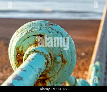 Green railings with rust and peeling paint at beach in Brighton Sussex ...