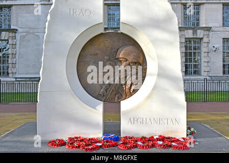 Wreath & close up of Iraq war Afghanistan war & Gulf War Memorial to British citizens sculptor Paul Day in Portland stone with bronze medallion tondo Stock Photo