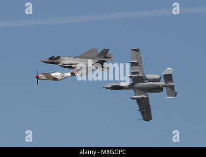 The Heritage Flight, comprising of the P-51 Mustang, F-35 Lightning II and A-10 Thunderbolt, breaks off at the end of its performance during Luke Days at Luke Air Force Base, Ariz., March 17, 2018. Luke Days demonstrates the capabilities of modern military and civilian airpower through the display of more than 30 live air and ground demonstrations and static exhibits. (U.S. Air Force photo by Senior Airman James Hensley) Stock Photo