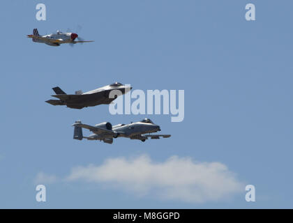 The Heritage Flight, comprising of the P-51 Mustang, F-35 Lightning II and A-10 Thunderbolt, performs a flyby during Luke Days at Luke Air Force Base, Ariz., March 17, 2018. Luke Days demonstrates the capabilities of modern military and civilian airpower through the display of more than 30 live air and ground demonstrations and static exhibits. (U.S. Air Force photo by Senior Airman James Hensley) Stock Photo