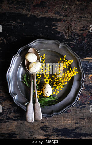 Spring table setting with bright yellow mimosa flowers Stock Photo