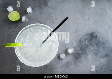 Margarita Сocktail with lime and ice on grey concrete background, copy space. Classic Margarita or Daiquiry Cocktail. Stock Photo