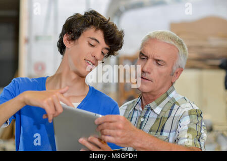 Carptenters using tablet computer Stock Photo