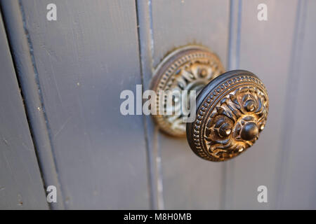 Rusted doorknob, old door handle on rustic wooden door in village of Roussillon, Provence, France Stock Photo