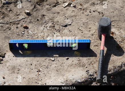 Assorted work tools on wood and tile Stock Photo