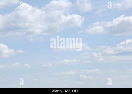 Shining sun among the blue sky and white clouds Stock Photo