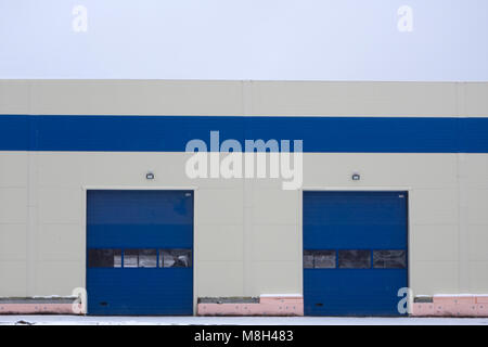 Blue metal gates and doors beige wall Stock Photo