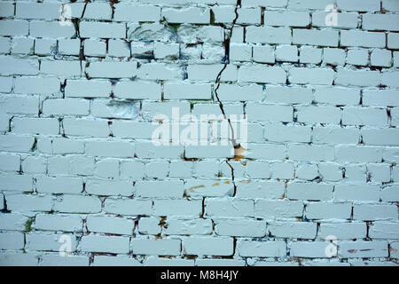 Background of blue vintage brick wall with white plaster stucco texture Stock Photo