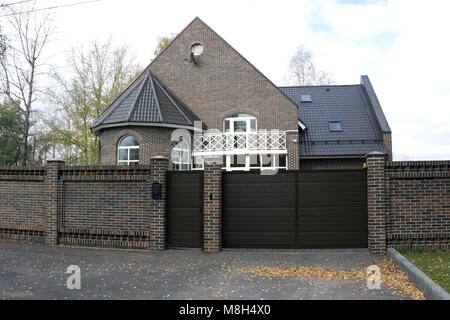 Exterior of a large two story brick residential home containing plenty of copy space Stock Photo