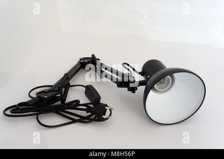 Intimate atmosphere in the hotel room. Bedside table on which lie the leather folder of the menu, do not disturb the sign and the lamp with a textile  Stock Photo