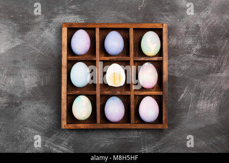Multicolored eggs for Easter on black background. Top view. Food background Stock Photo