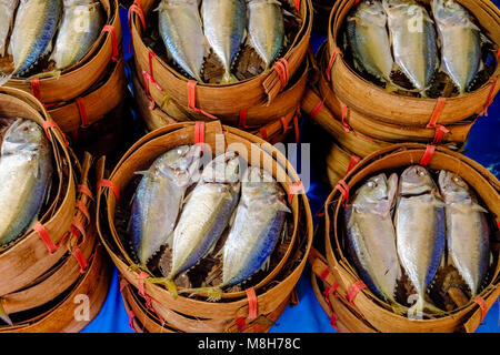 Fresh fishes in bamboo baskets are for sale at Nonthaburi Market Stock Photo