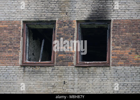 Interior of burnt by fire apartment in an apartment building, burned furniture, can be used as war concept Stock Photo