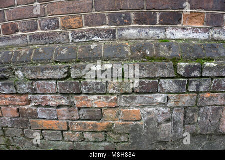 Very old pale red brick wall as background or wallpaper. Brick texture and pattern Stock Photo